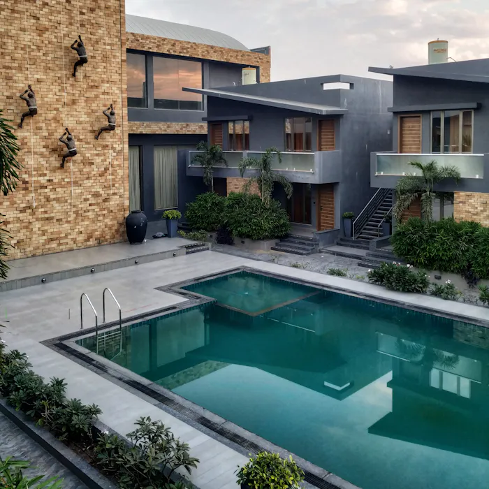A rectangular pool beside a contemporary building facade.