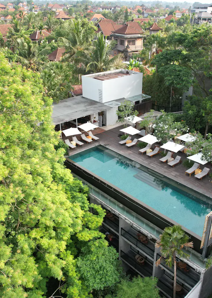Aerial view of a resort swimming pool surrounded by landscaped decking.