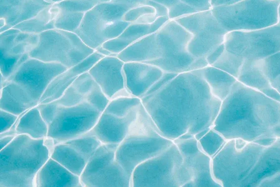 Clear, balanced pool water catching the sunlight.