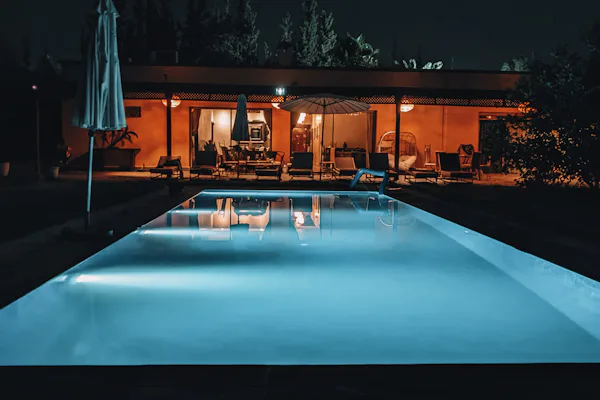 A swimming pool lit from within after dark.